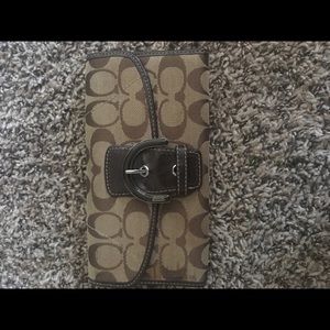 Brown trifold coach wallet